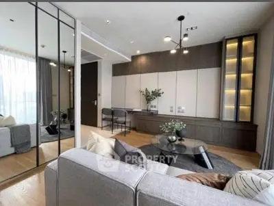 Modern living room with stylish decor and large windows offering natural light.