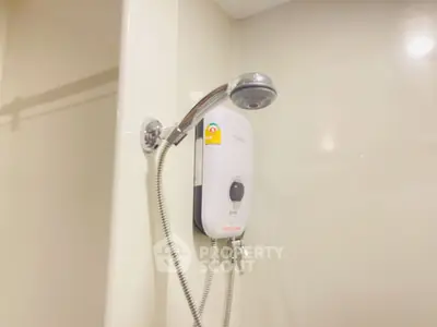 Modern bathroom with sleek showerhead and water heater, perfect for a comfortable home experience.