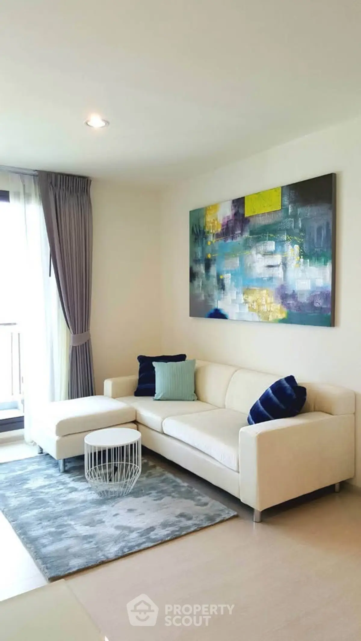 Modern living room with stylish decor and large window for natural light