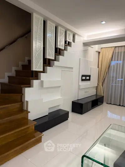 Modern living room with stylish staircase and elegant decor