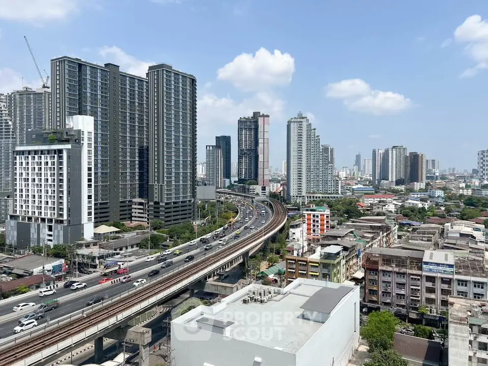 Stunning cityscape view with modern high-rise buildings and bustling highway, perfect for urban living enthusiasts.