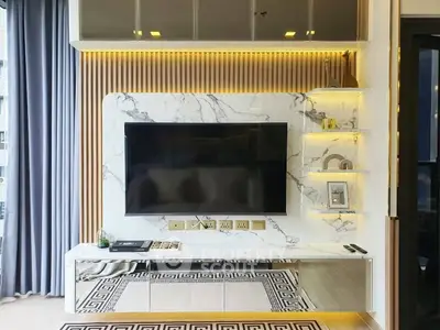 Luxurious living room with marble TV wall and modern decor