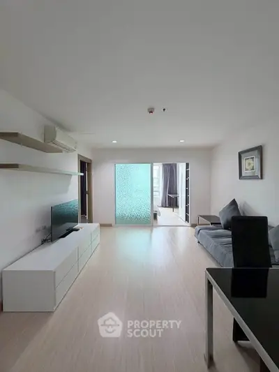 Spacious modern living room with sleek furniture and natural light