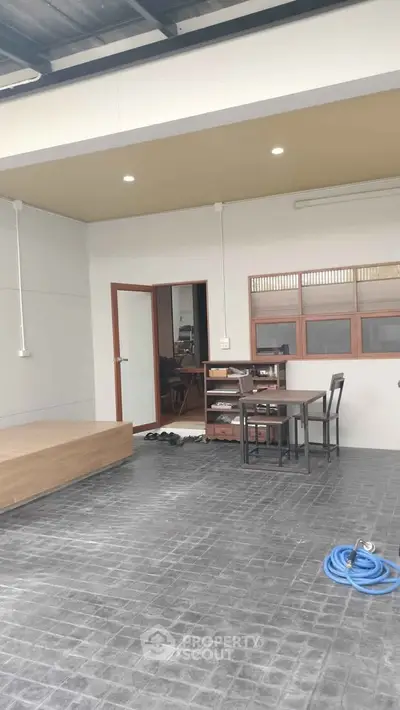 Modern outdoor patio with dining set and wooden deck, perfect for relaxation and entertainment.