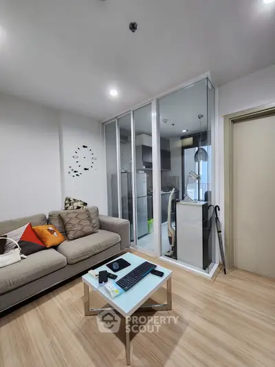 Modern living room with glass partition and cozy decor in a stylish apartment