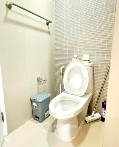 Modern bathroom with sleek toilet and tiled walls