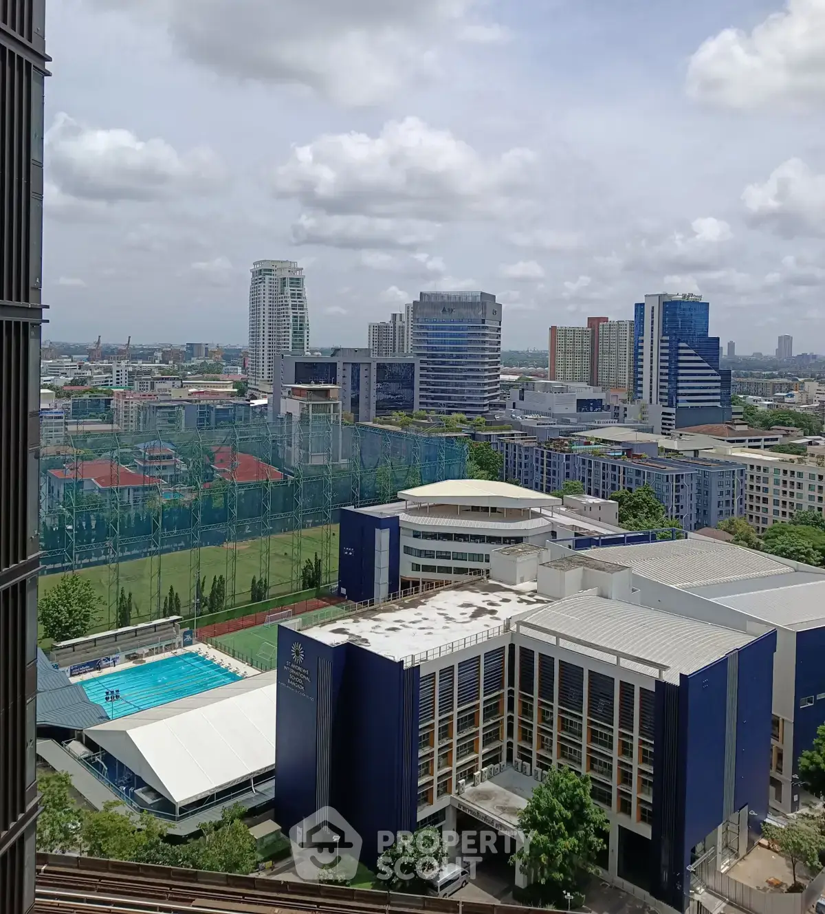 Stunning cityscape view from high-rise building with pool and sports facilities