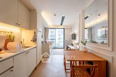 Chic open-plan kitchen and living room with modern decor and balcony view.