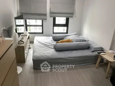 Cozy bedroom with modern decor and large windows for natural light