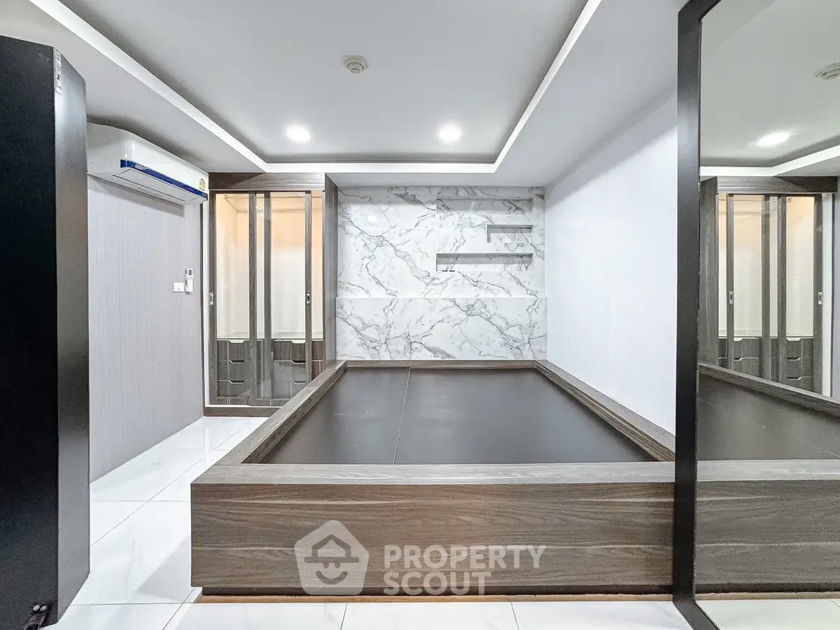 Modern bedroom with sleek design and marble accent wall