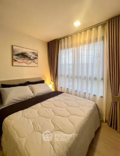 Cozy bedroom with soft lighting and elegant curtains, perfect for relaxation.