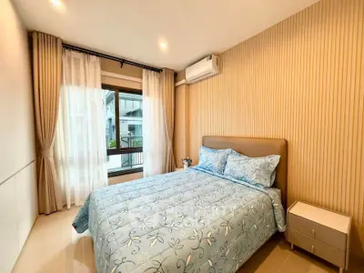 Cozy modern bedroom with large window and stylish decor