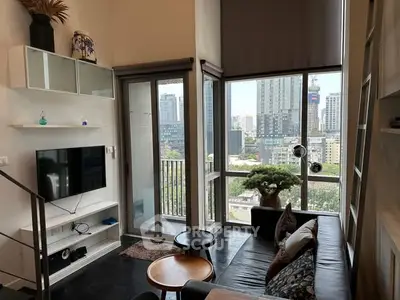 Modern living room with city view, sleek furniture, and large windows.