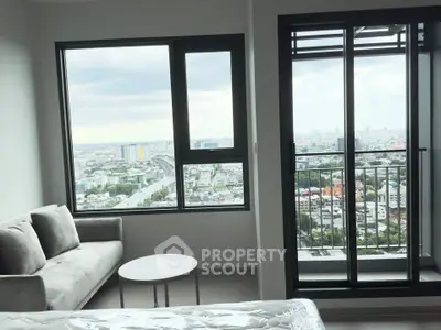 Modern apartment with stunning city view from living room and balcony, featuring sleek furnishings.