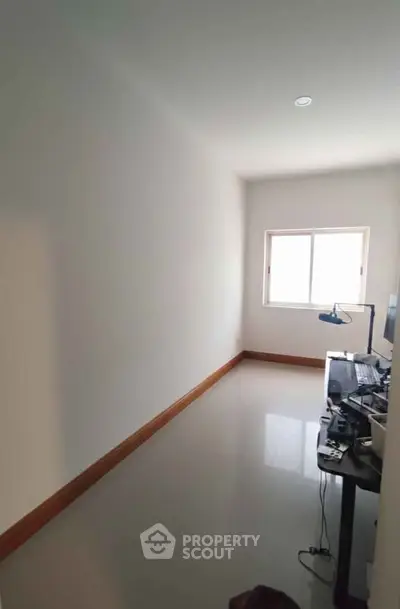 Minimalist study room with sleek desk and computer setup, perfect for productivity and focus.