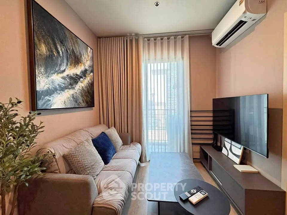 Modern living room with stylish decor, large TV, and cozy seating area.