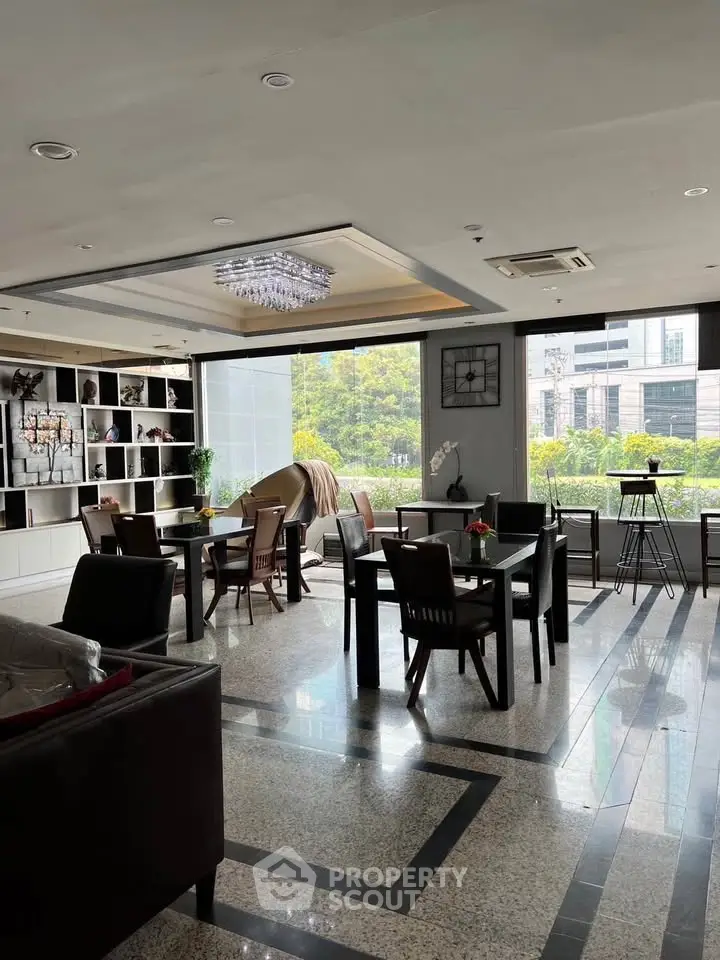 Spacious modern living area with elegant decor and large windows offering a scenic view.