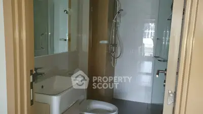 Modern bathroom with sleek fixtures and glass shower enclosure
