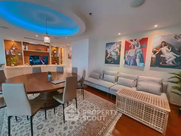 Luxurious living room with elegant decor and ambient lighting, featuring a spacious seating area and stylish dining setup.