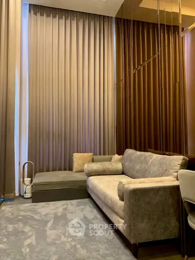 Luxurious living room with elegant sofa and floor-to-ceiling curtains