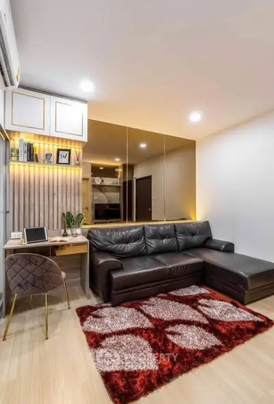 Modern living room with stylish decor, leather sofa, and cozy rug in a contemporary apartment.