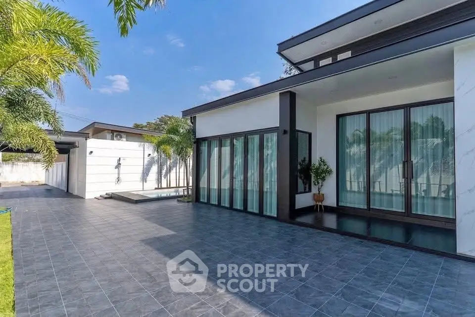 Modern luxury home with spacious patio and pool, perfect for outdoor living.