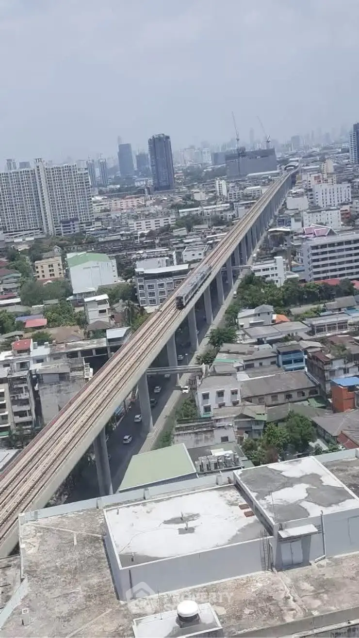 Stunning aerial view of urban cityscape with elevated train tracks and modern high-rise buildings.