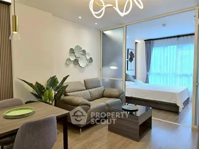 Modern open-plan living room with stylish decor and cozy bedroom