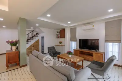 Spacious living room with modern decor and cozy seating area