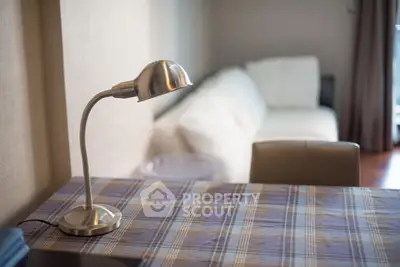 Cozy living room with modern lamp and comfortable sofa, perfect for relaxation.