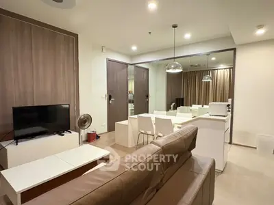 Modern living room with sleek furniture and open layout in a stylish apartment.