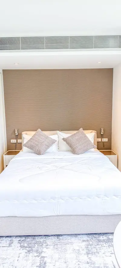 Luxurious bedroom with modern design, featuring a plush bed and elegant decor, perfect for relaxation and comfort.