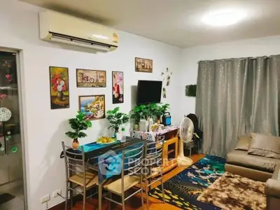Cozy living room with modern decor, air conditioning, and stylish furniture in a vibrant apartment.