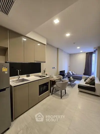 Modern open-layout kitchen and living room with sleek design and neutral tones.