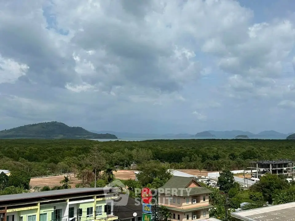 Scenic view of lush greenery and distant mountains from a high vantage point, ideal for nature lovers.