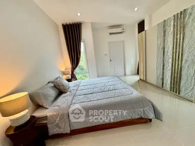 Spacious modern bedroom with large bed and mirrored wardrobe