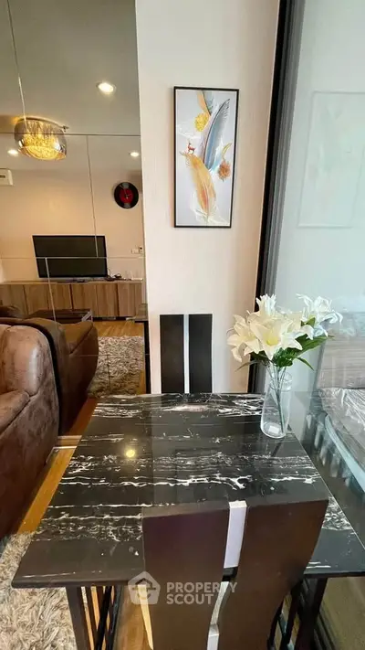 Modern dining area with elegant marble table and stylish decor in a cozy living space.