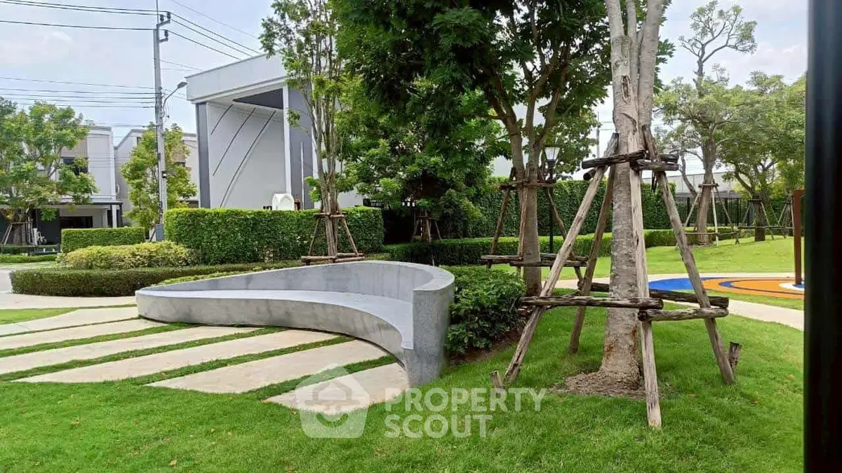 Modern garden with curved seating and lush greenery in a residential area