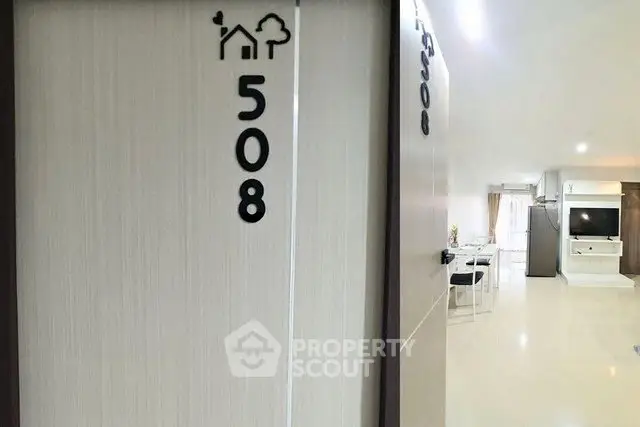 Modern apartment entrance with open view into spacious living area