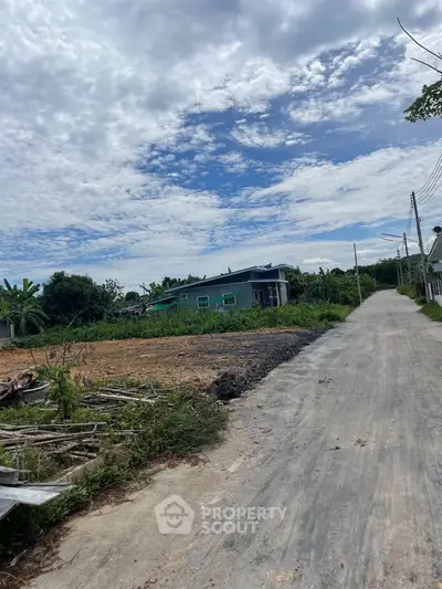 Charming rural property with lush greenery and a serene road view, perfect for tranquil living.