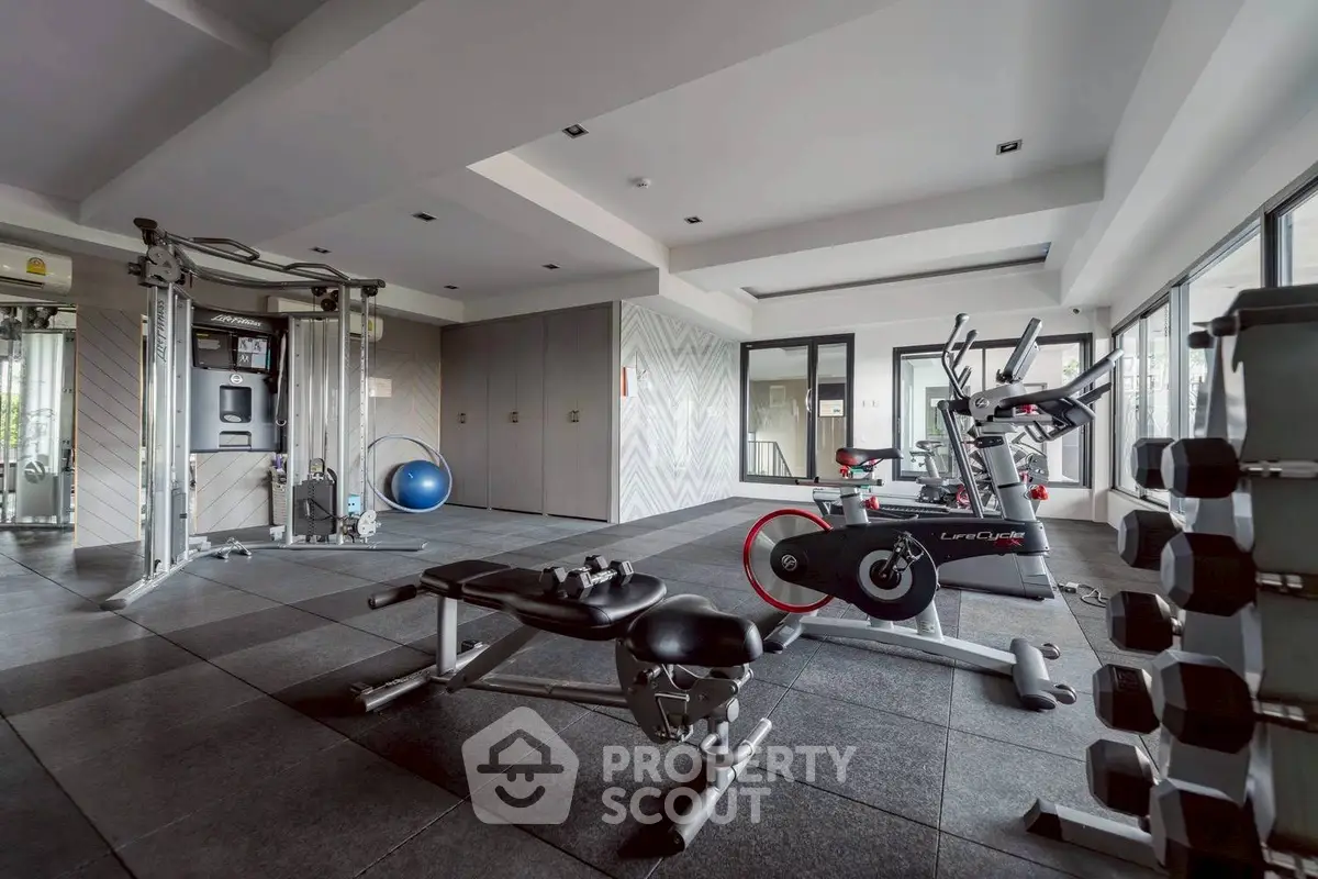 Modern gym with state-of-the-art equipment in a luxury residential building.