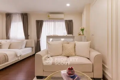 Elegant living room with cozy sofa and stylish decor in modern apartment.