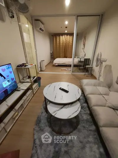Cozy living room with modern decor and bedroom view