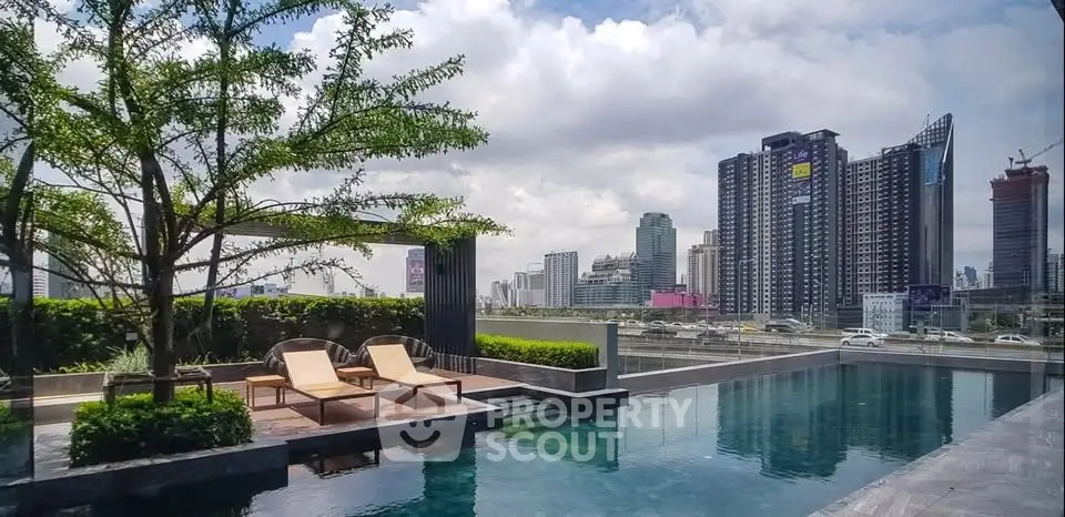 Luxurious rooftop pool with stunning city skyline view, perfect for urban living enthusiasts.