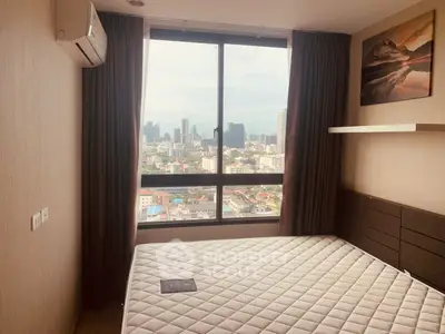 Modern bedroom with city view, featuring large window and air conditioning, perfect for urban living.