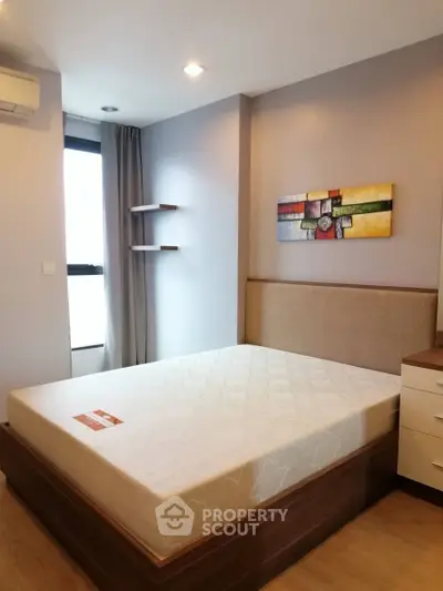 Modern bedroom with stylish decor and natural light