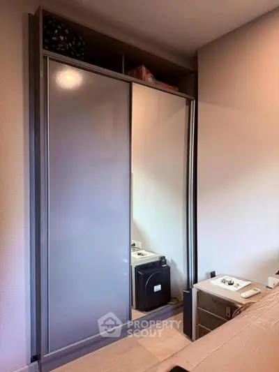Modern bedroom with sleek sliding wardrobe and stylish decor
