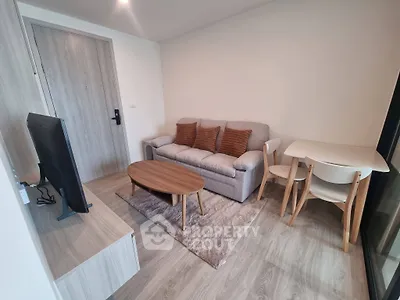 Modern living room with cozy sofa and stylish decor in a compact apartment.
