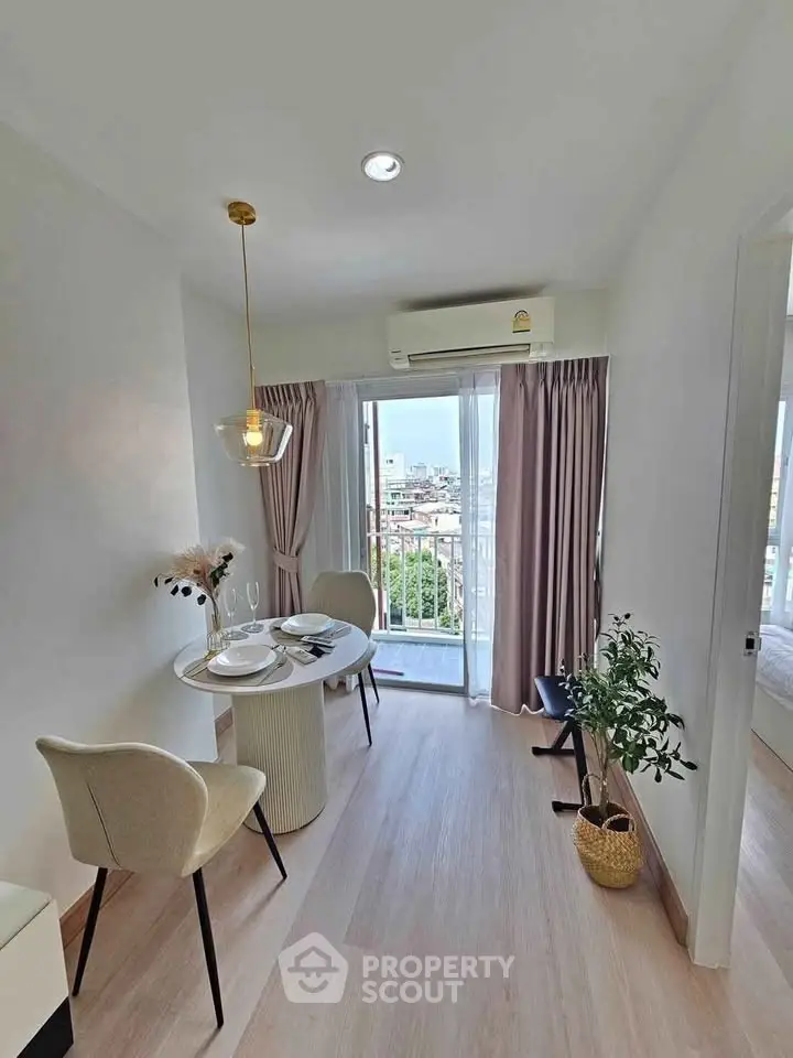 Chic dining area with balcony view in modern apartment, featuring elegant decor and natural light.