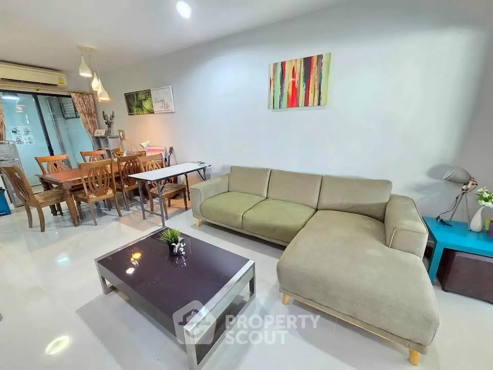 Spacious living room with modern decor and dining area, perfect for family gatherings.